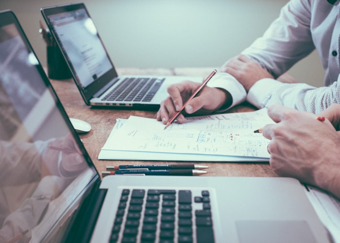 Payroll documents being reviewed at a desk